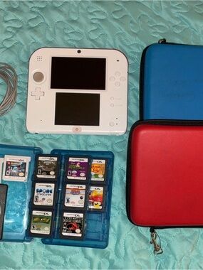 Nintendo White 2DS with 22 Games With Blue Game Case and Red Carry Case.